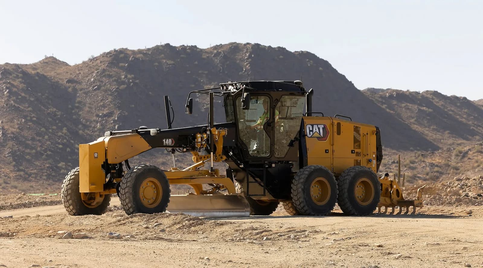 Motor grader grading a road